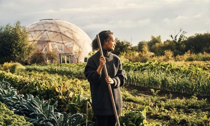 Woman standing in a field of diverse crops