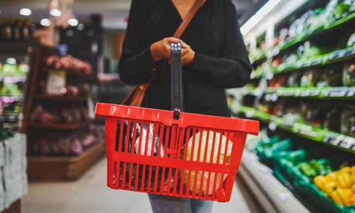 A woman shops for food in a supermarket